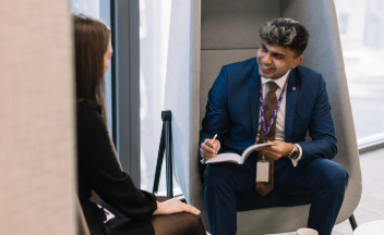 Brokers in office having a conversation and taking notes