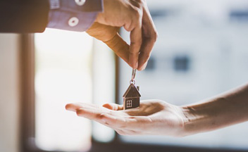 Close up of someone handing over keys