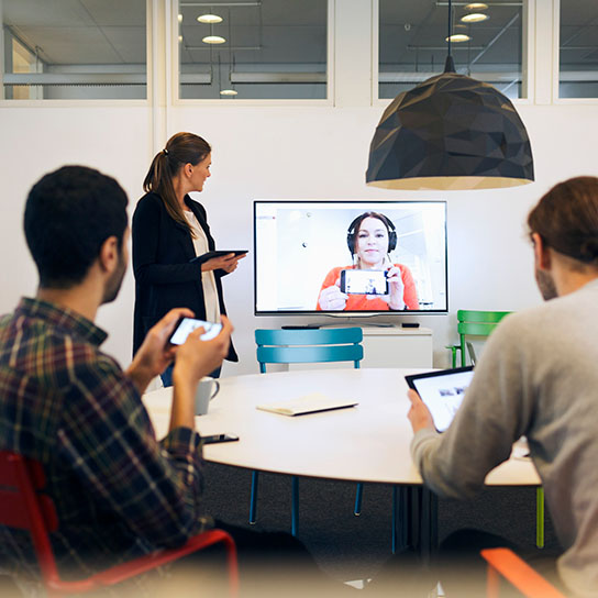 Young people in office environment using video call software