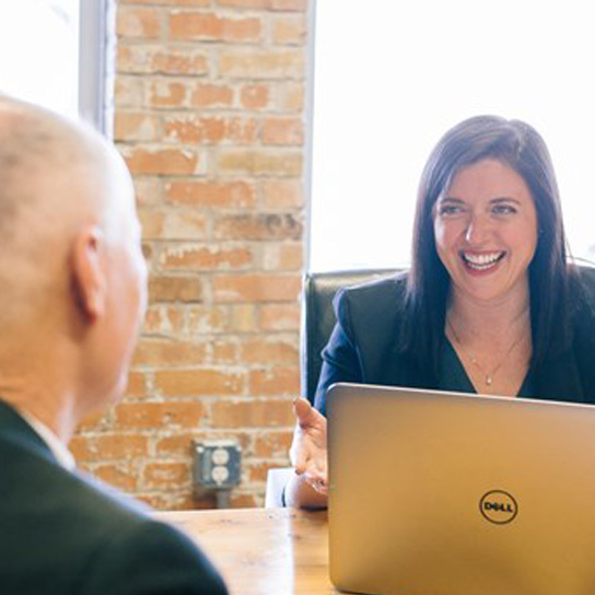 Lady in office interacting with man