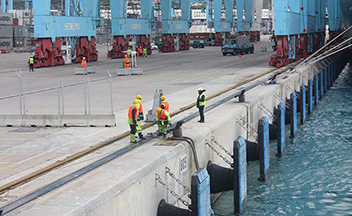 Marine workers on the side of shipping dock