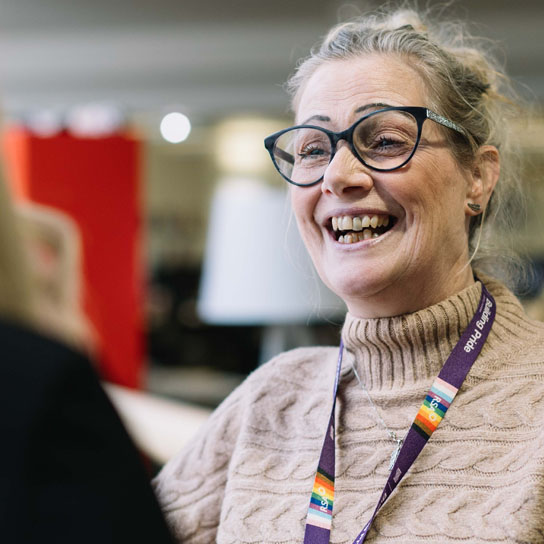 Lady in glasses talking in Peterborough office