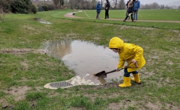 Photo of child in Naunton Park digging a flooded corner