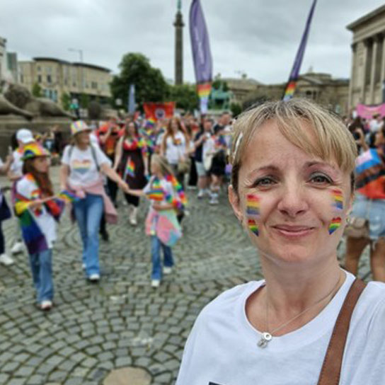 Gail Hardy with rainbow face paint at pride event