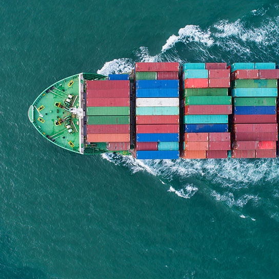 Aerial shot of green ship transporting cargo