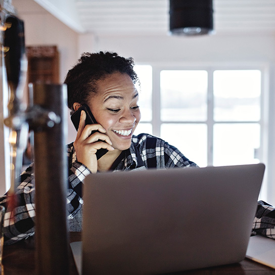 Lady on phone using a laptop