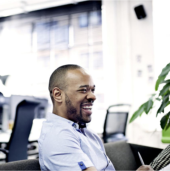 Man sitting in an office smiling