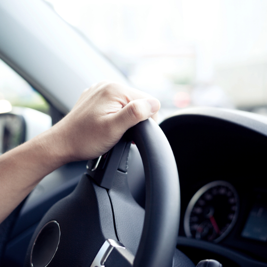 Hand on steering wheel.