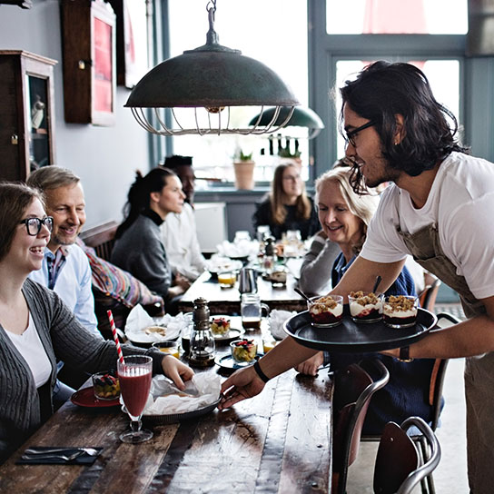 Man serving food in cafe