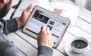 Man using a tablet with coffee