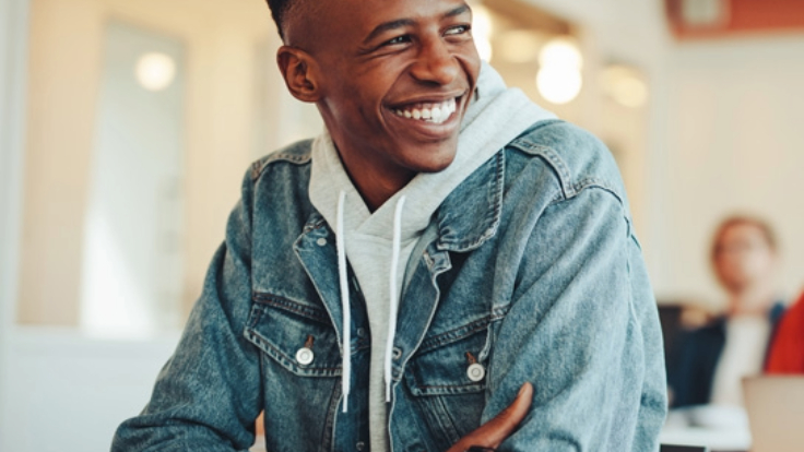 Young male apprentice in denim jacket and hoodie.
