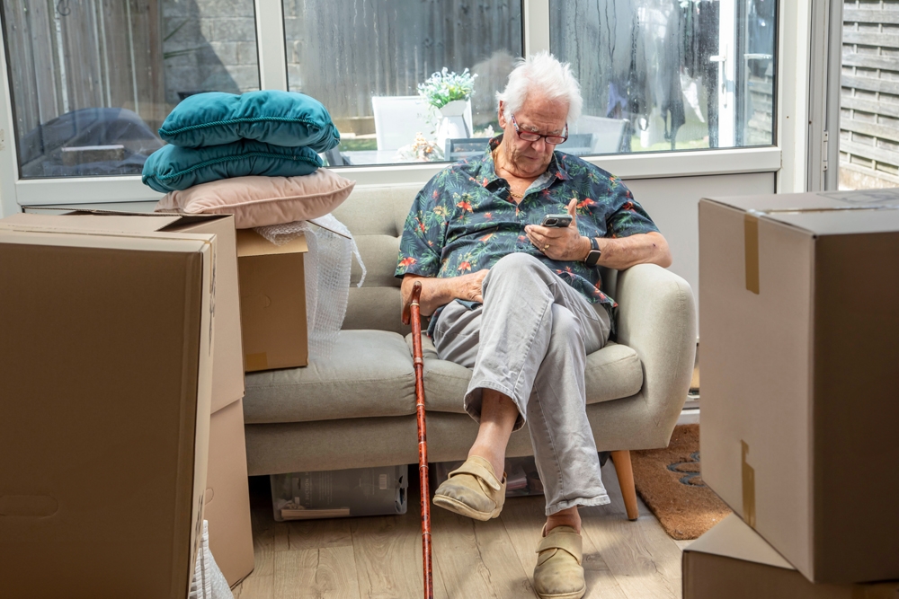 man sitting in a chair on a smartphone