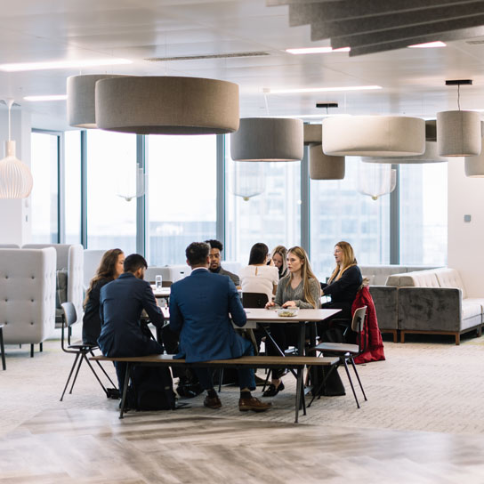 People using different working spaces in RSA London office