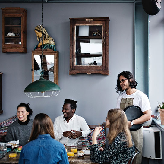 People in a restaurant with waiter