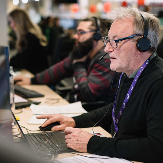 Older man with a headset in Peterborough office