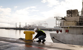 Man securing ship with rope