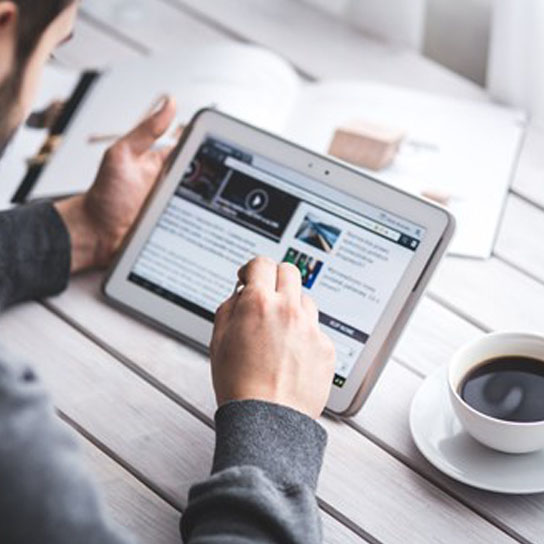 Man using a tablet with coffee