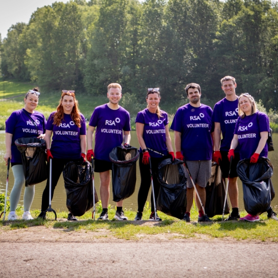 Group photo of RSA volunteers as they were litter picking. The group are stood in a single line smiling at the camera.