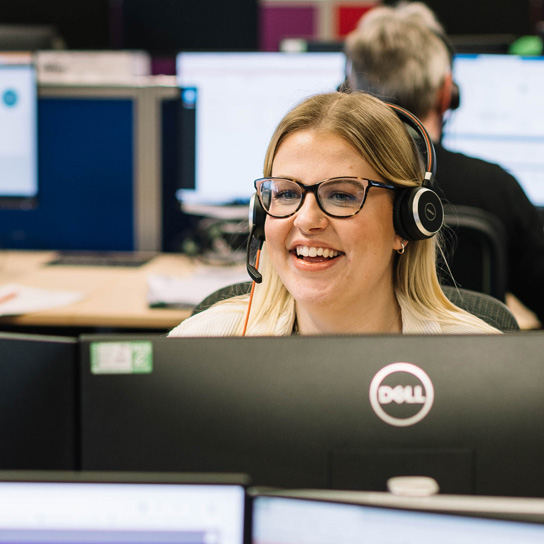 Lady with glasses smiling in Peterborough office