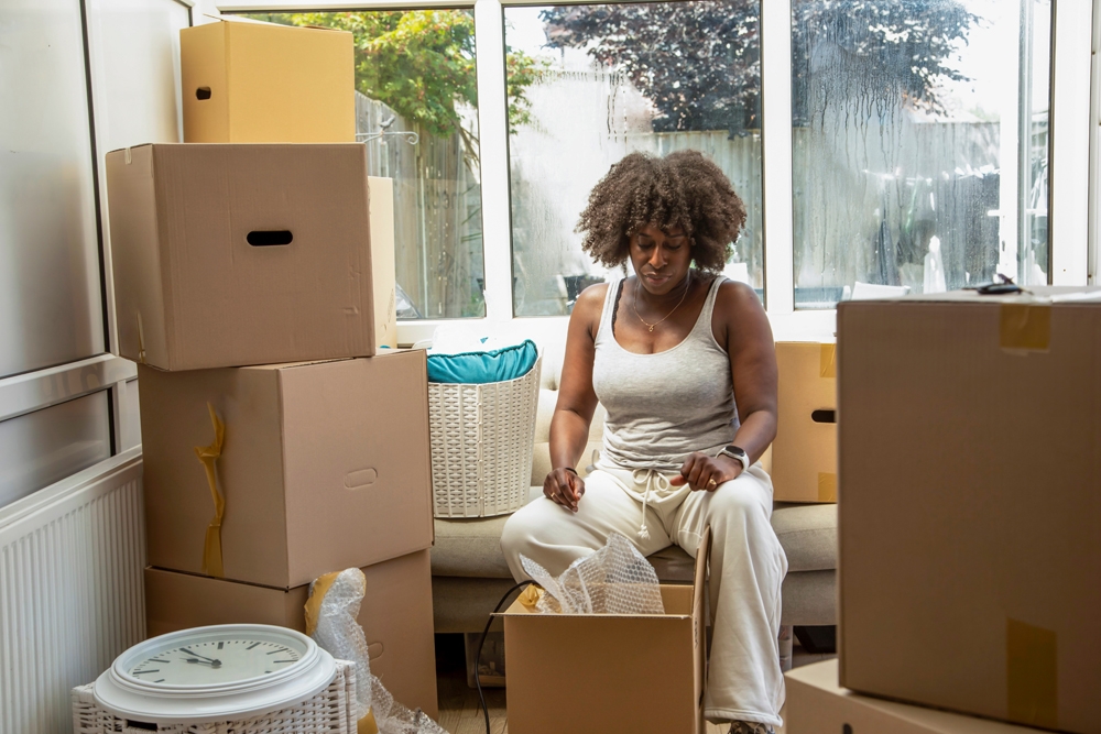 woman in a house surrounded by boxes