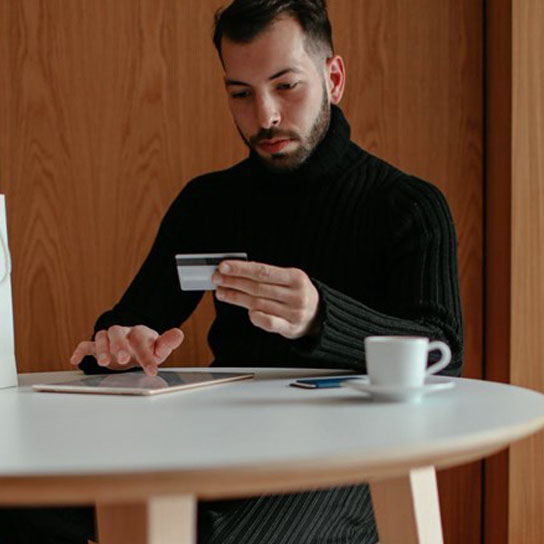 Man using tablet making payment with card