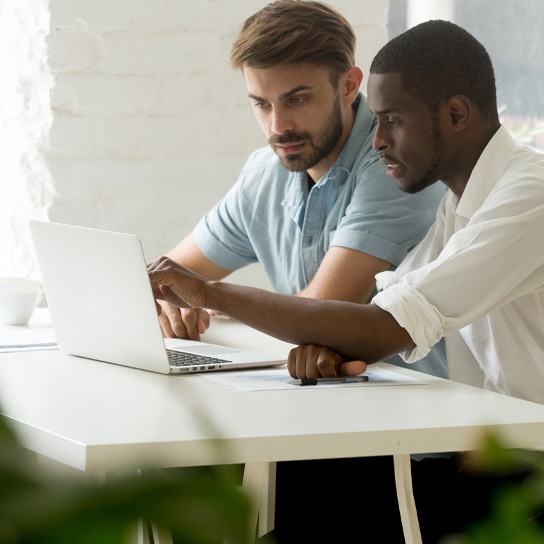 Two men on a laptop