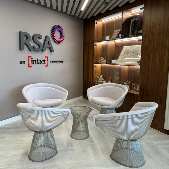 London office reception area, with seats and a table, display cabinet and the RSA and Intact logo on the wall