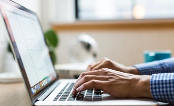 Close up of person using laptop