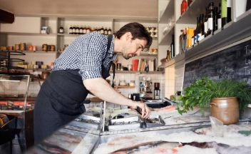 Man wearing apron in fishmongers
