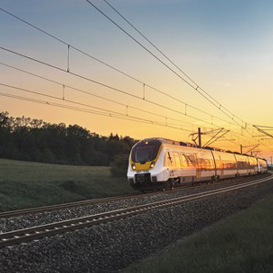Train moving at sunset