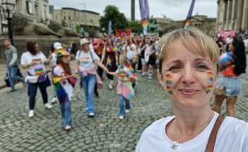 Gail Hardy with rainbow face paint at pride event