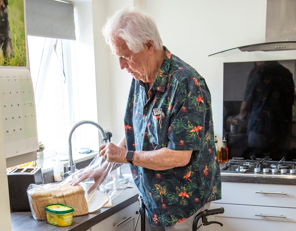 man making some toast in a kitchen