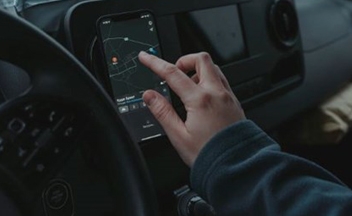 Close up person using phone in car