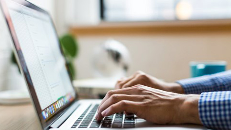 Close up of person using laptop