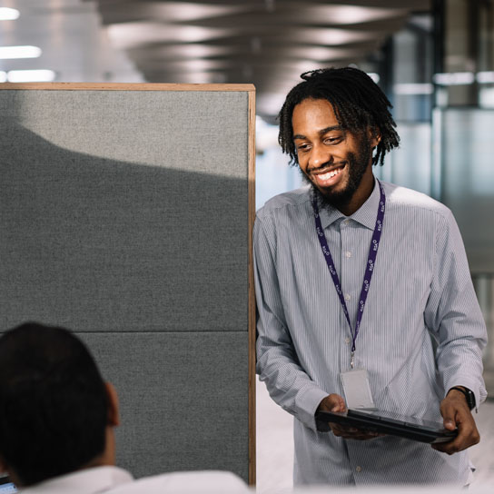 Man stood at side of desk in RSA London office