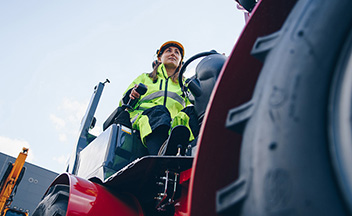 Woman operating construction vehicle