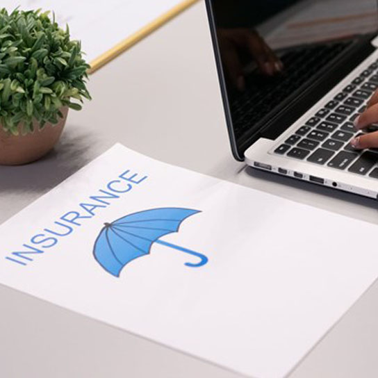 Insurance document and laptop
