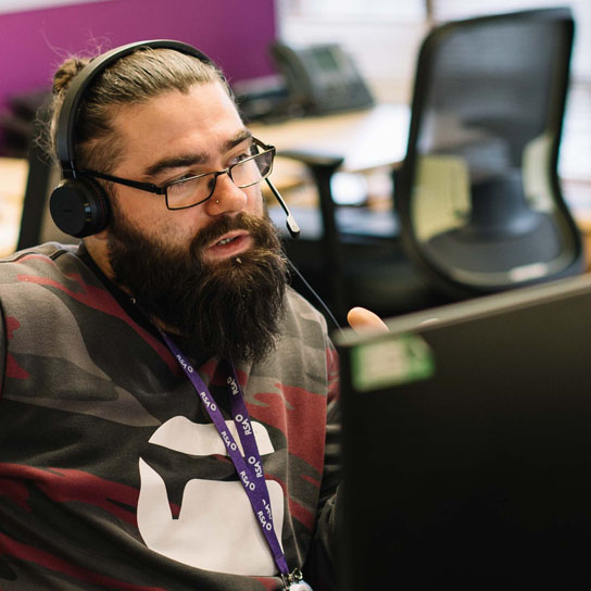 Young man wearing headset in Peterborough office